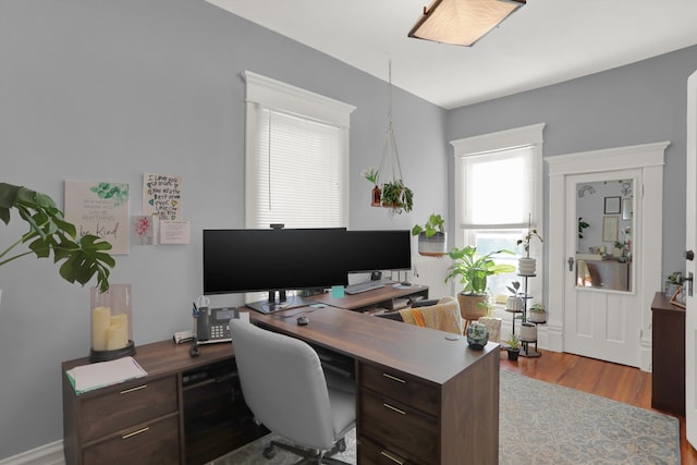 home office with light hardwood / wood-style floors