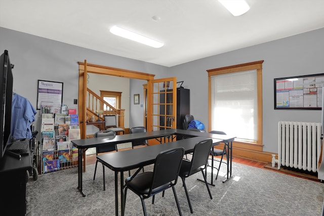 dining room with hardwood / wood-style floors and radiator heating unit