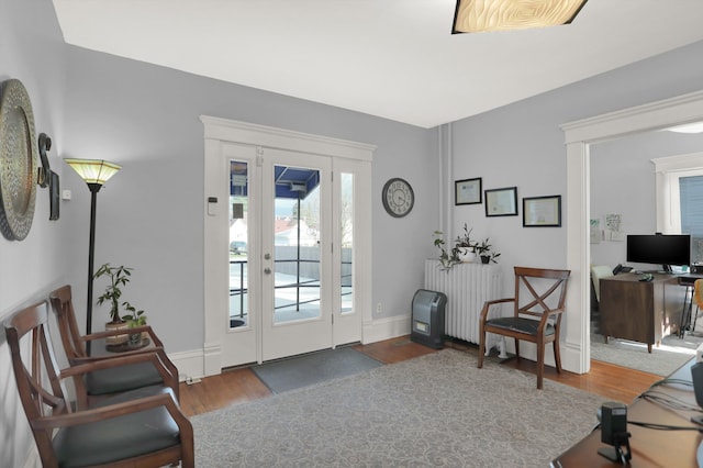 foyer with dark hardwood / wood-style flooring and radiator heating unit