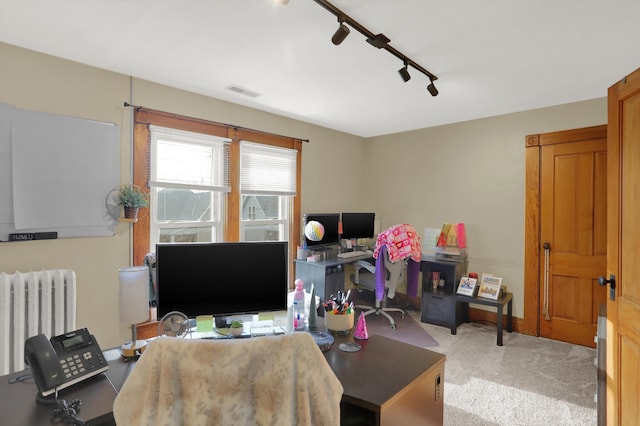 office area with light carpet, rail lighting, and radiator