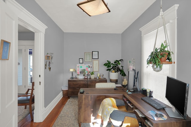 home office with dark hardwood / wood-style floors