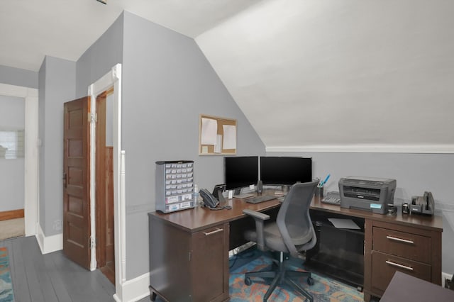 home office with vaulted ceiling and dark hardwood / wood-style floors