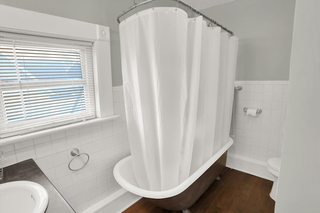 bathroom featuring tile walls, sink, toilet, and hardwood / wood-style flooring