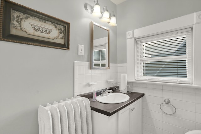 bathroom featuring backsplash, tile walls, and vanity