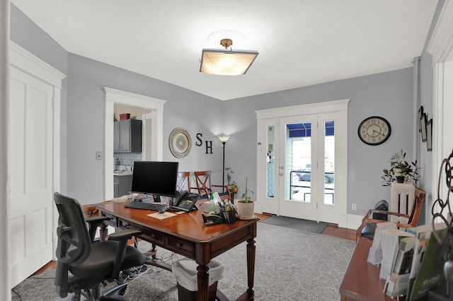 home office with dark wood-type flooring