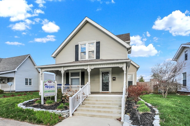 bungalow with covered porch and a front yard