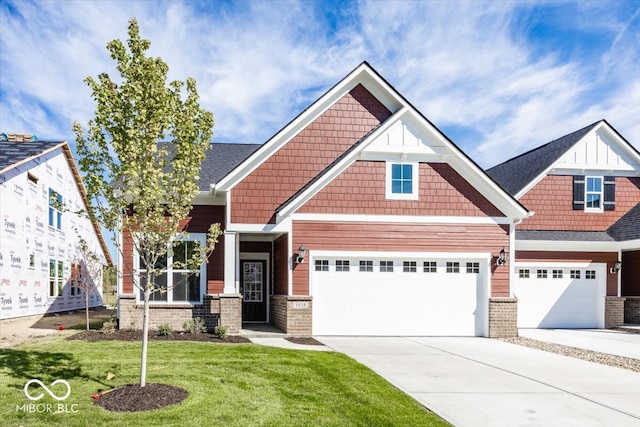 craftsman inspired home with a garage and a front lawn