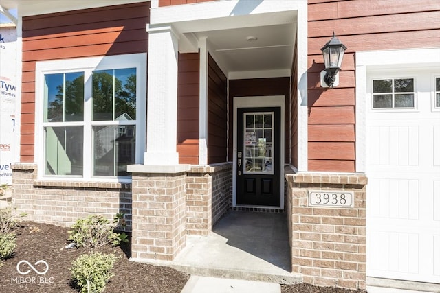 doorway to property with a garage