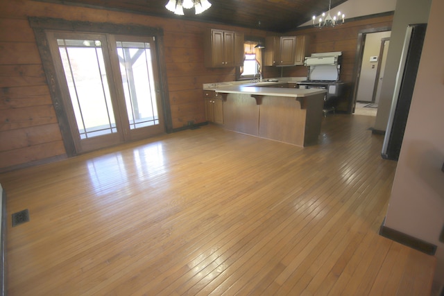 kitchen featuring dark hardwood / wood-style flooring, a chandelier, hanging light fixtures, and a wealth of natural light