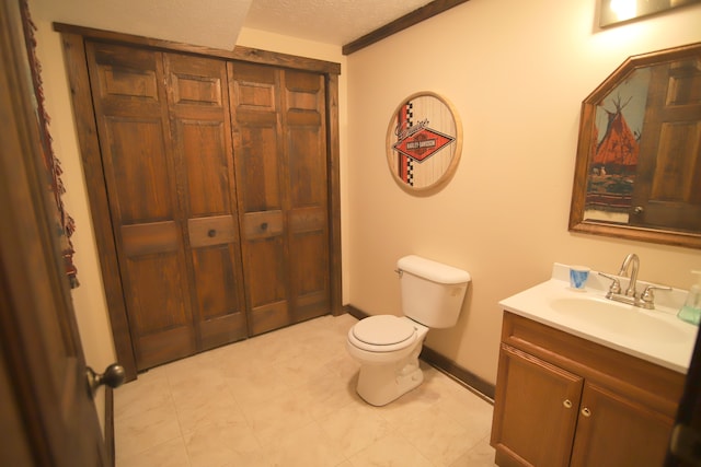 bathroom featuring tile floors, toilet, a textured ceiling, and vanity