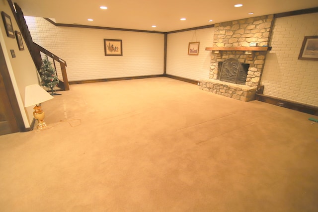 basement with carpet and a stone fireplace