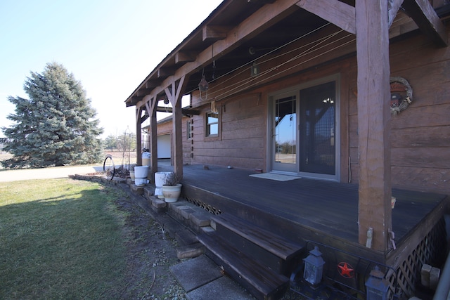 view of property exterior with a yard and a wooden deck