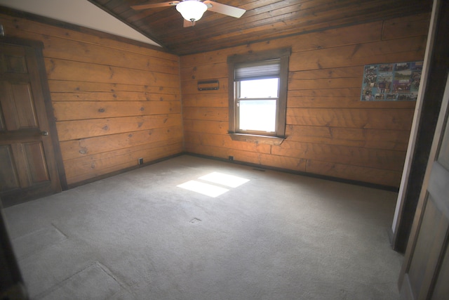 unfurnished room featuring ceiling fan, dark colored carpet, vaulted ceiling, wooden walls, and wood ceiling