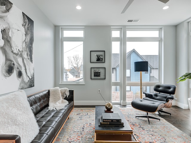 living room featuring dark hardwood / wood-style floors and a wall of windows