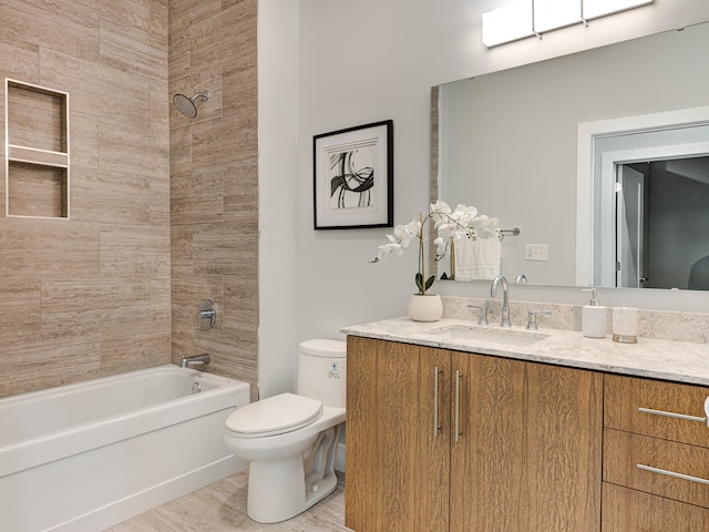 full bathroom with hardwood / wood-style floors, toilet, vanity, and tiled shower / bath