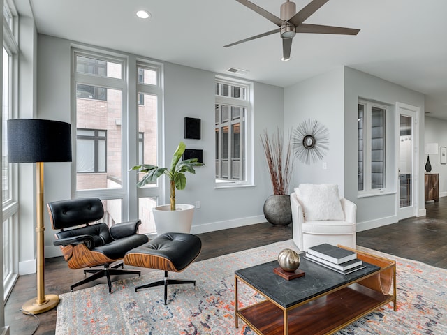 living room with ceiling fan and dark hardwood / wood-style flooring