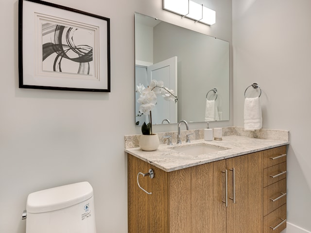 bathroom featuring toilet and vanity