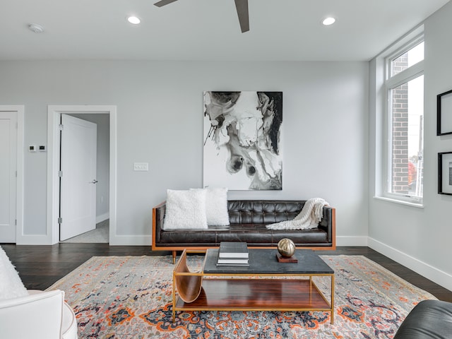 living room with ceiling fan and dark hardwood / wood-style flooring