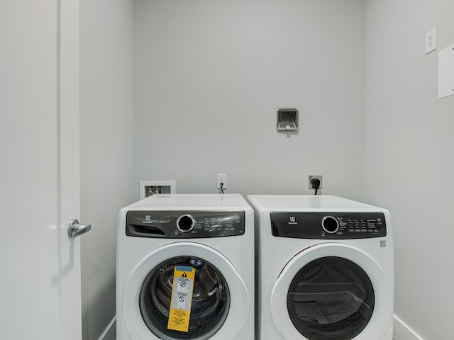 laundry area featuring washer hookup, washing machine and dryer, and hookup for an electric dryer