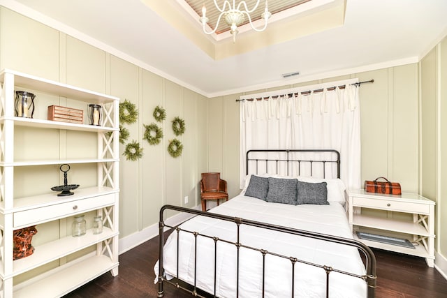 bedroom featuring an inviting chandelier, dark hardwood / wood-style floors, and ornamental molding