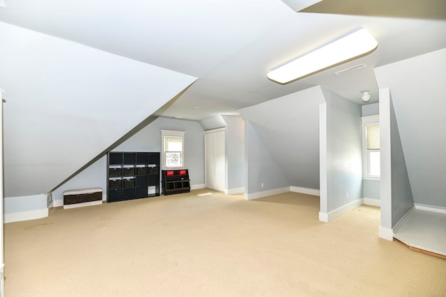 bonus room with light colored carpet