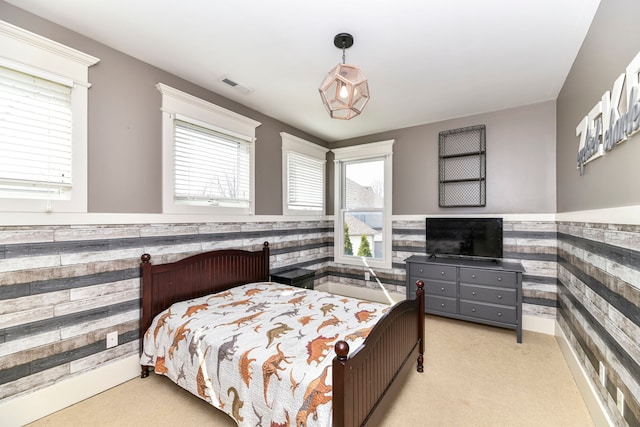 carpeted bedroom with multiple windows