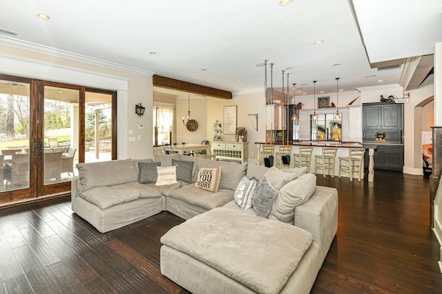 living room featuring dark hardwood / wood-style floors, french doors, and ornamental molding