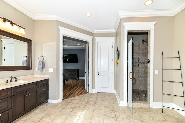 bathroom featuring an enclosed shower, ornamental molding, vanity, and hardwood / wood-style floors