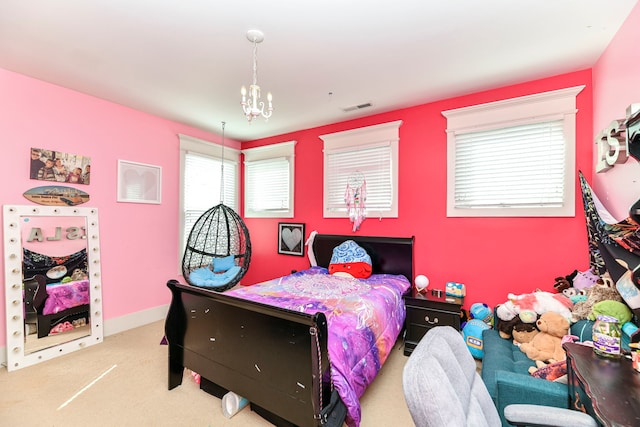 bedroom featuring a chandelier, light carpet, and multiple windows