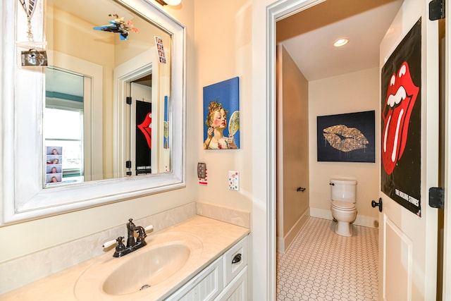 bathroom with tile flooring, oversized vanity, and toilet