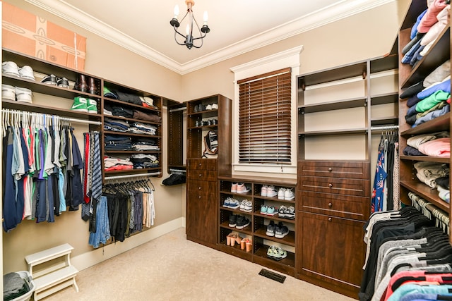 spacious closet featuring light carpet and a notable chandelier