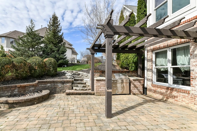 view of terrace with a grill and an outdoor kitchen