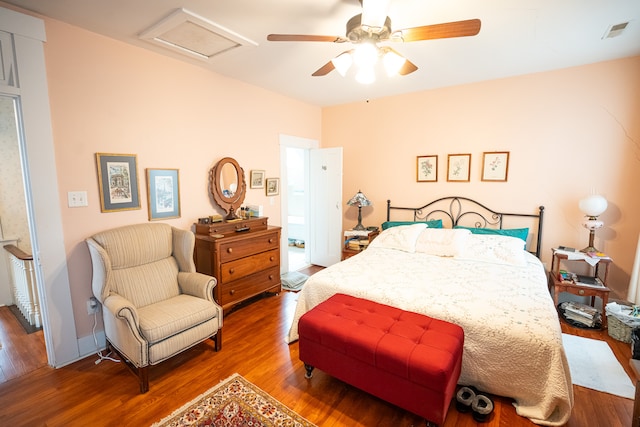 bedroom with dark hardwood / wood-style floors and ceiling fan