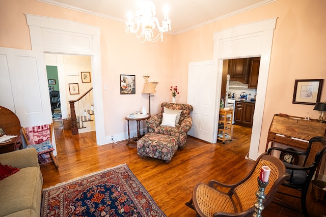 living room with crown molding, dark hardwood / wood-style flooring, and a chandelier