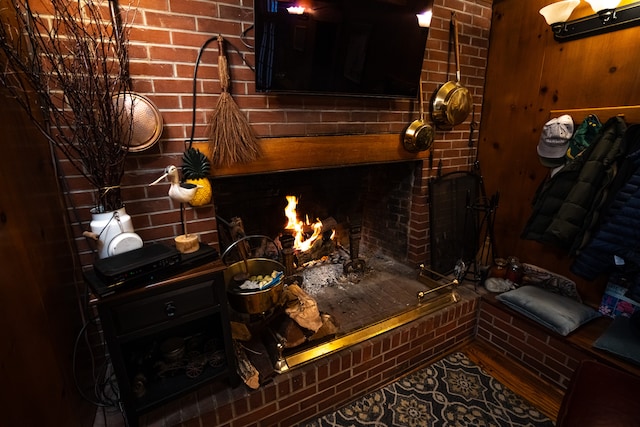 living room featuring brick wall and wooden walls