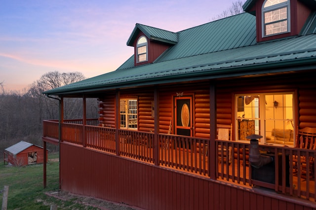 property exterior at dusk featuring a porch