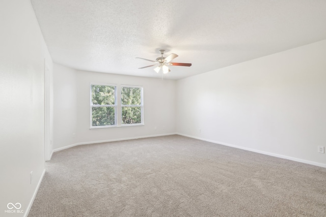 empty room with carpet floors, a textured ceiling, and ceiling fan