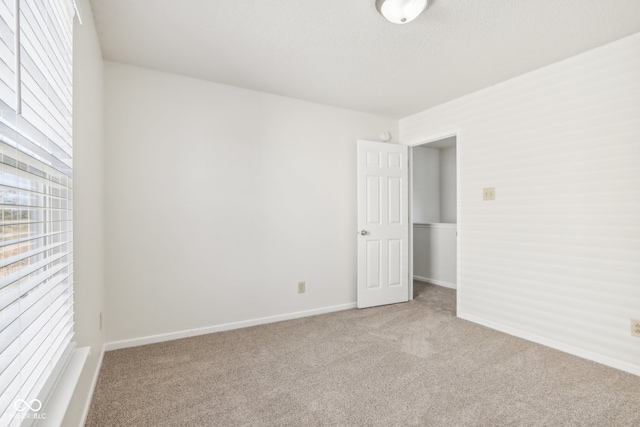 empty room featuring light carpet