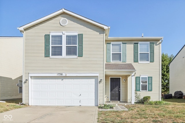 view of front of property with a garage and a front lawn