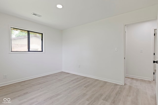 unfurnished room with light hardwood / wood-style floors