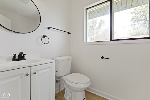 bathroom featuring vanity, hardwood / wood-style floors, and toilet