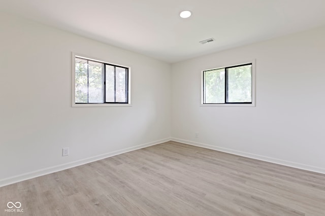 spare room with light hardwood / wood-style flooring