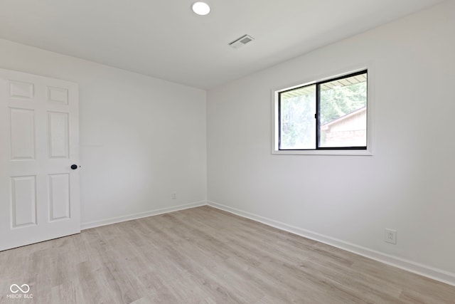 spare room featuring light hardwood / wood-style flooring