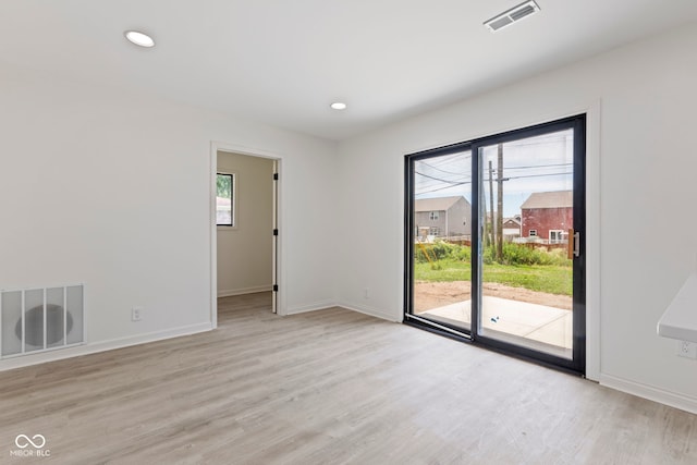 spare room featuring light hardwood / wood-style flooring