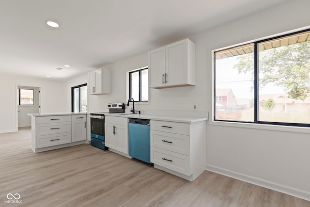 kitchen with sink, appliances with stainless steel finishes, kitchen peninsula, light hardwood / wood-style floors, and white cabinets