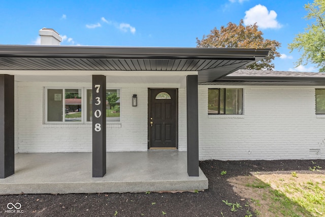 doorway to property featuring covered porch