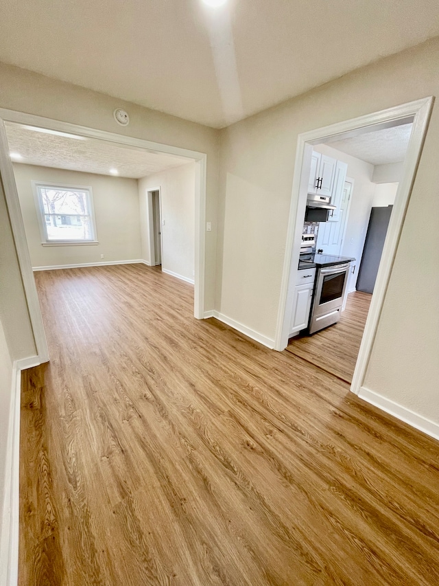 spare room featuring light wood-type flooring