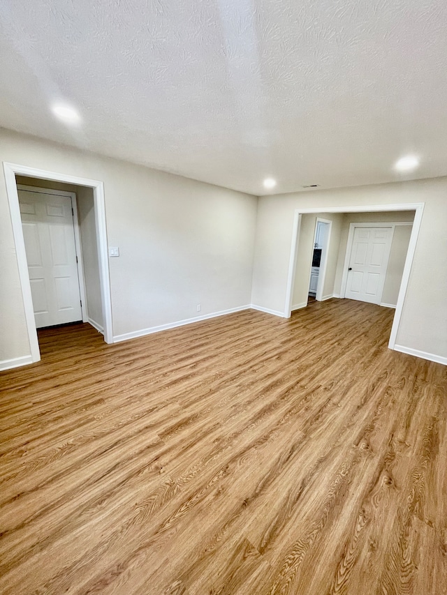 interior space featuring a textured ceiling and light hardwood / wood-style flooring