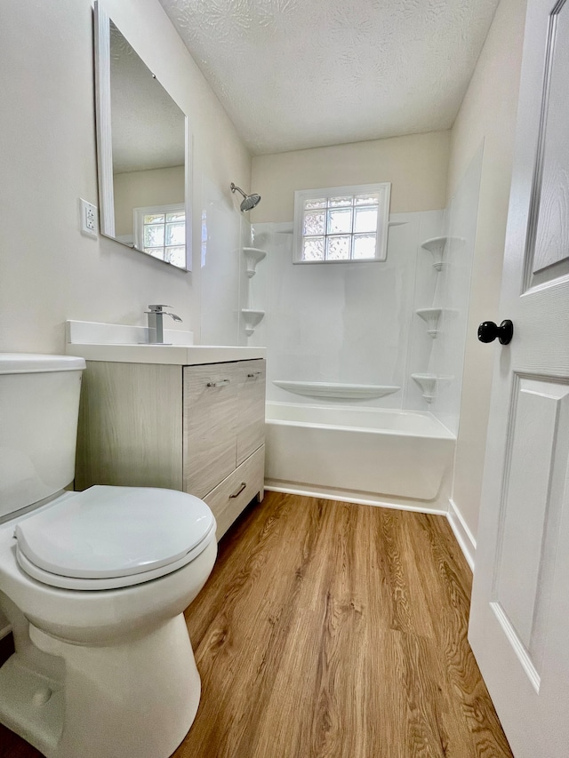 full bathroom with toilet, hardwood / wood-style floors, and plenty of natural light