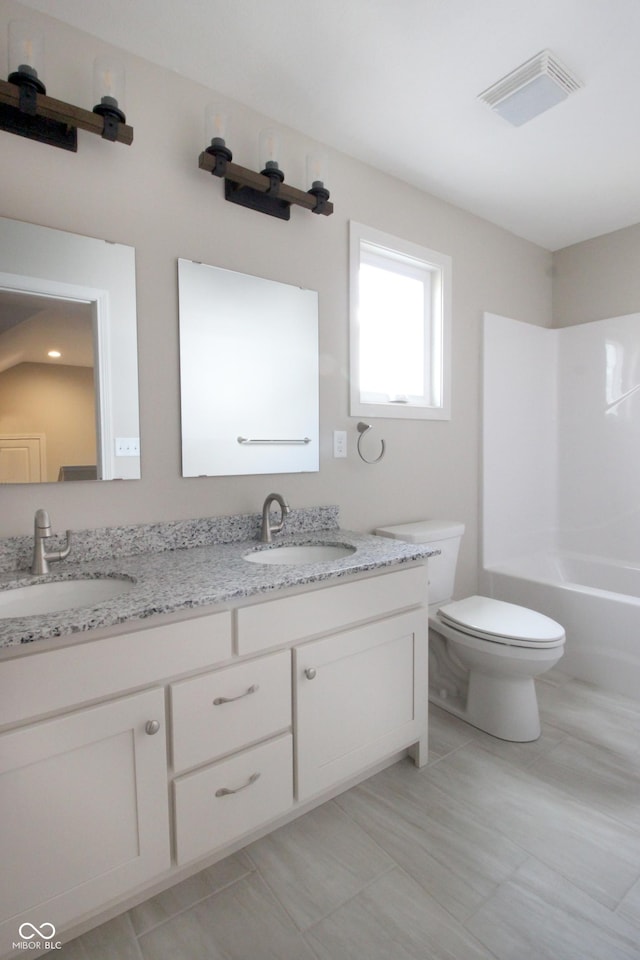 full bathroom featuring vanity, toilet, and  shower combination